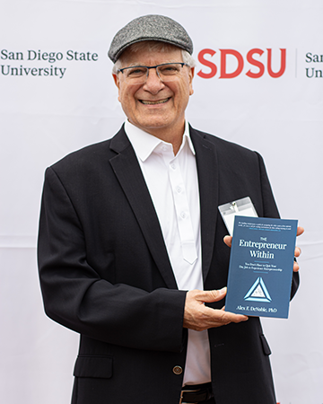 Alex Denoble with book