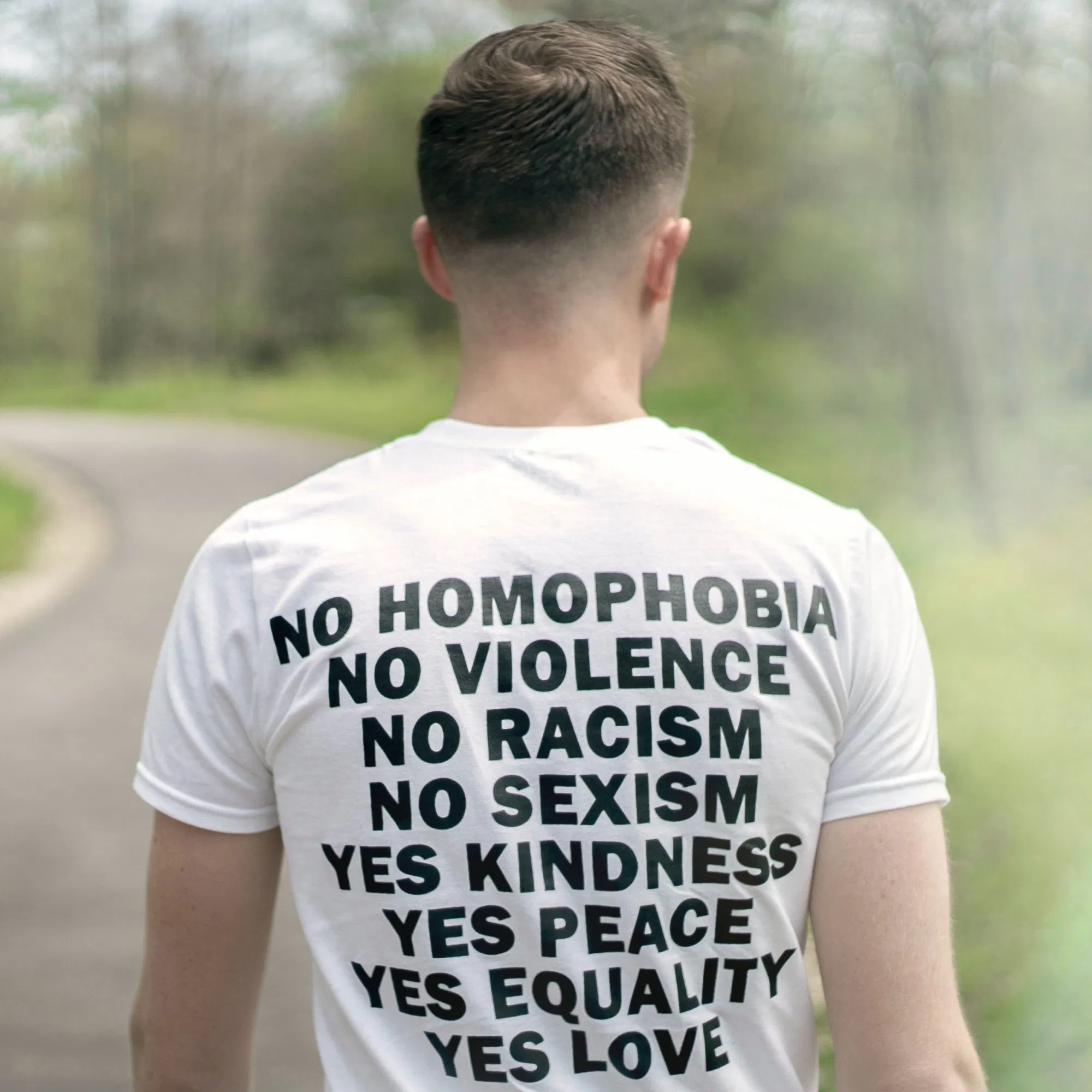 Back of shirt reads "No homophobia no violence no racism no sexism yes kindness yes pease yes equality yes love"
