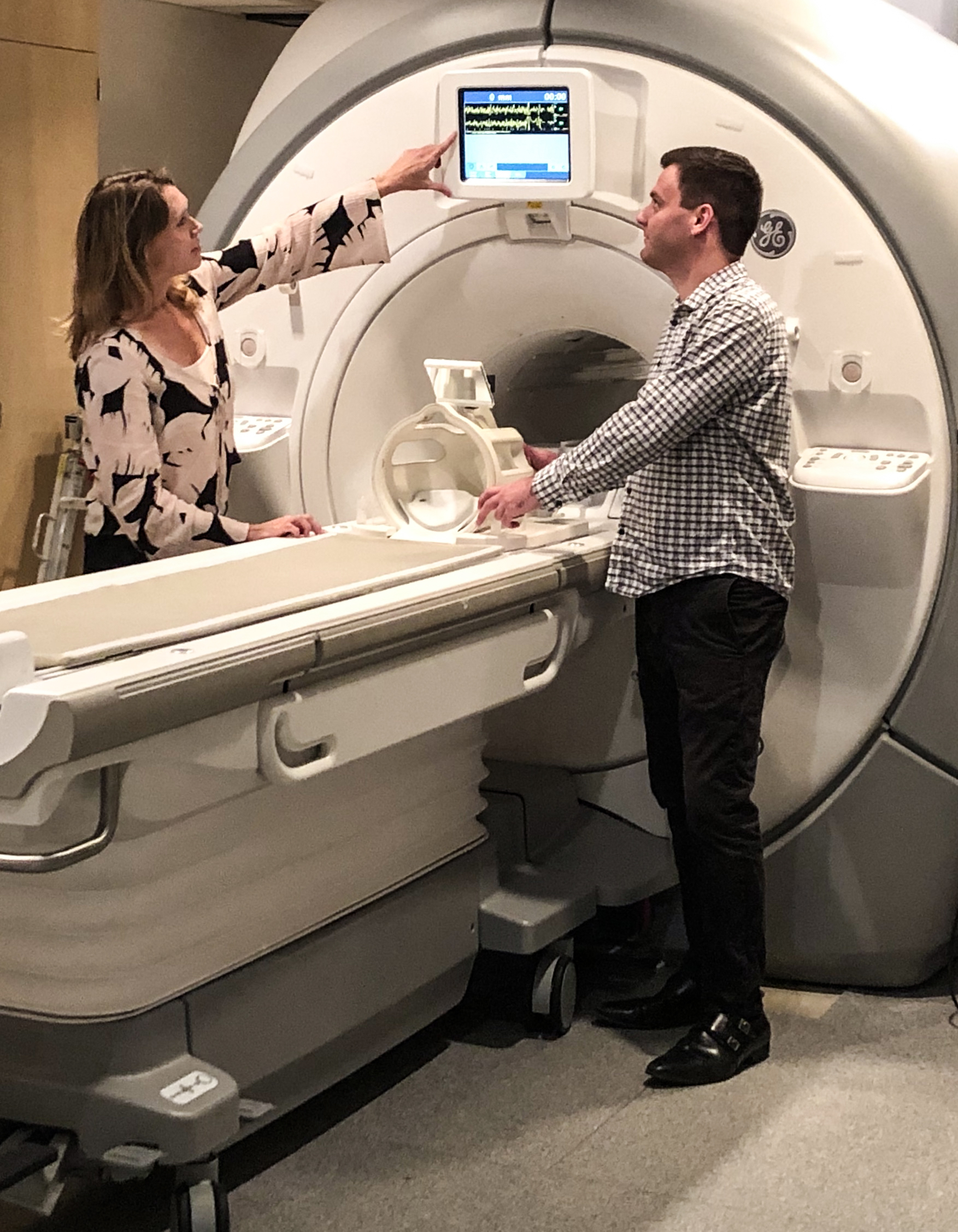 Dr. Maluf (left) and research assistant Mike Walsh (right) discuss functional magnetic resonance imaging (fMRI) of the brain and neck.