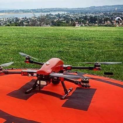 drone on landing pad in grass field